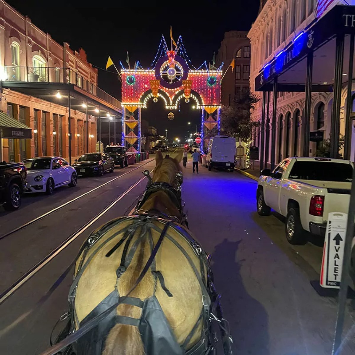 a person walking down a street next to a building
